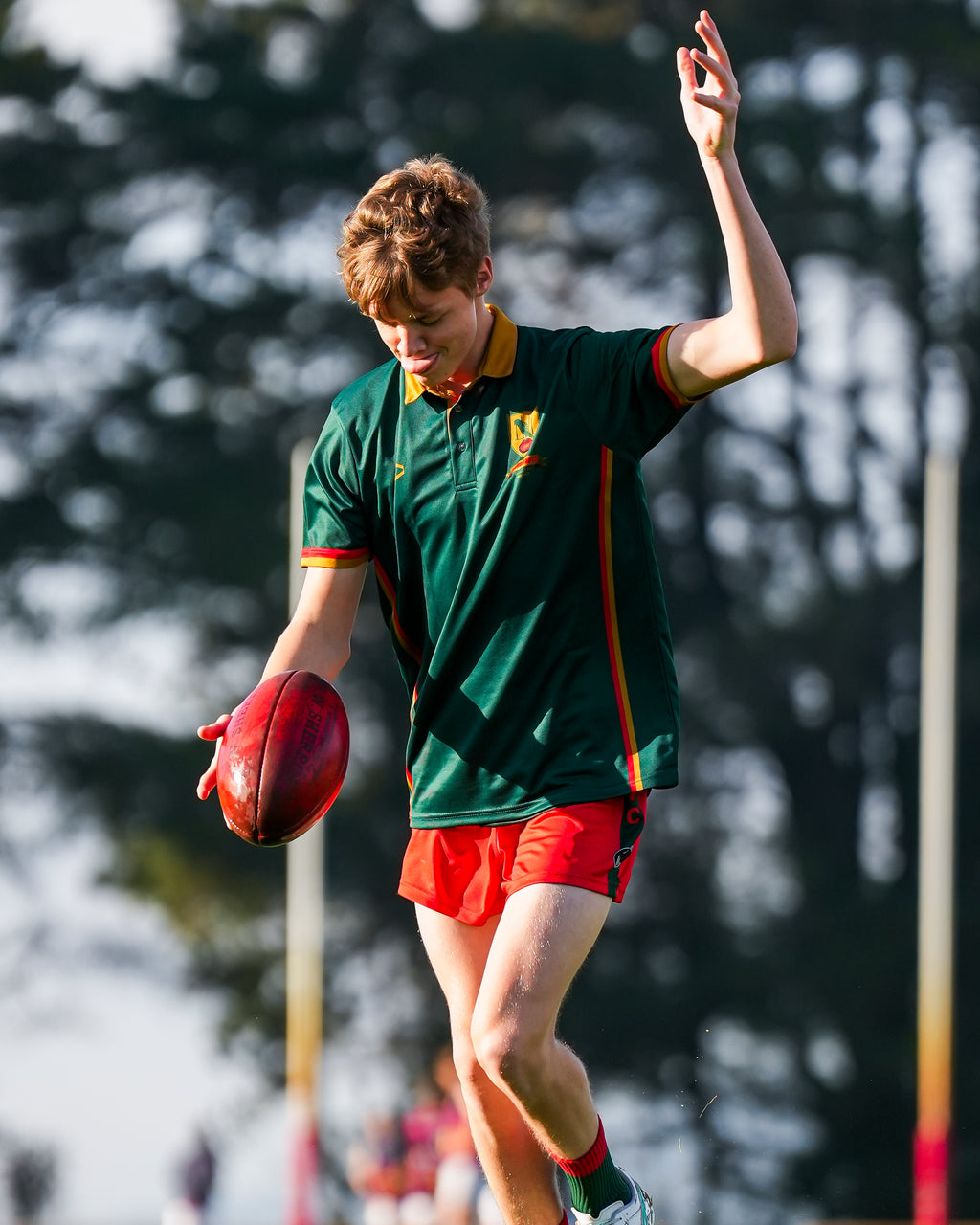 Person in Bridgenorth uniform with a ball, blurred background