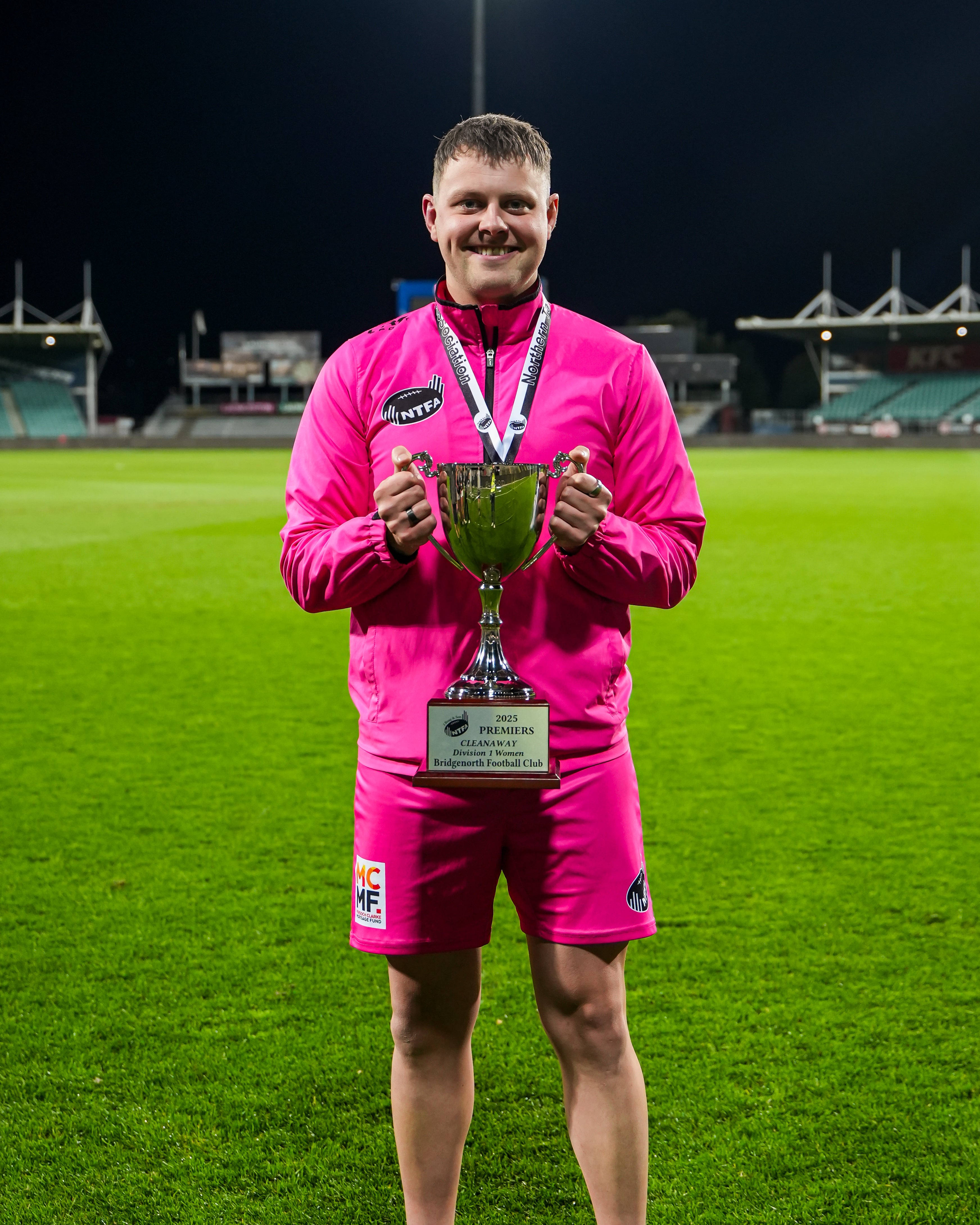 Aaron Woods holding the 2025 Grand Final Trophy