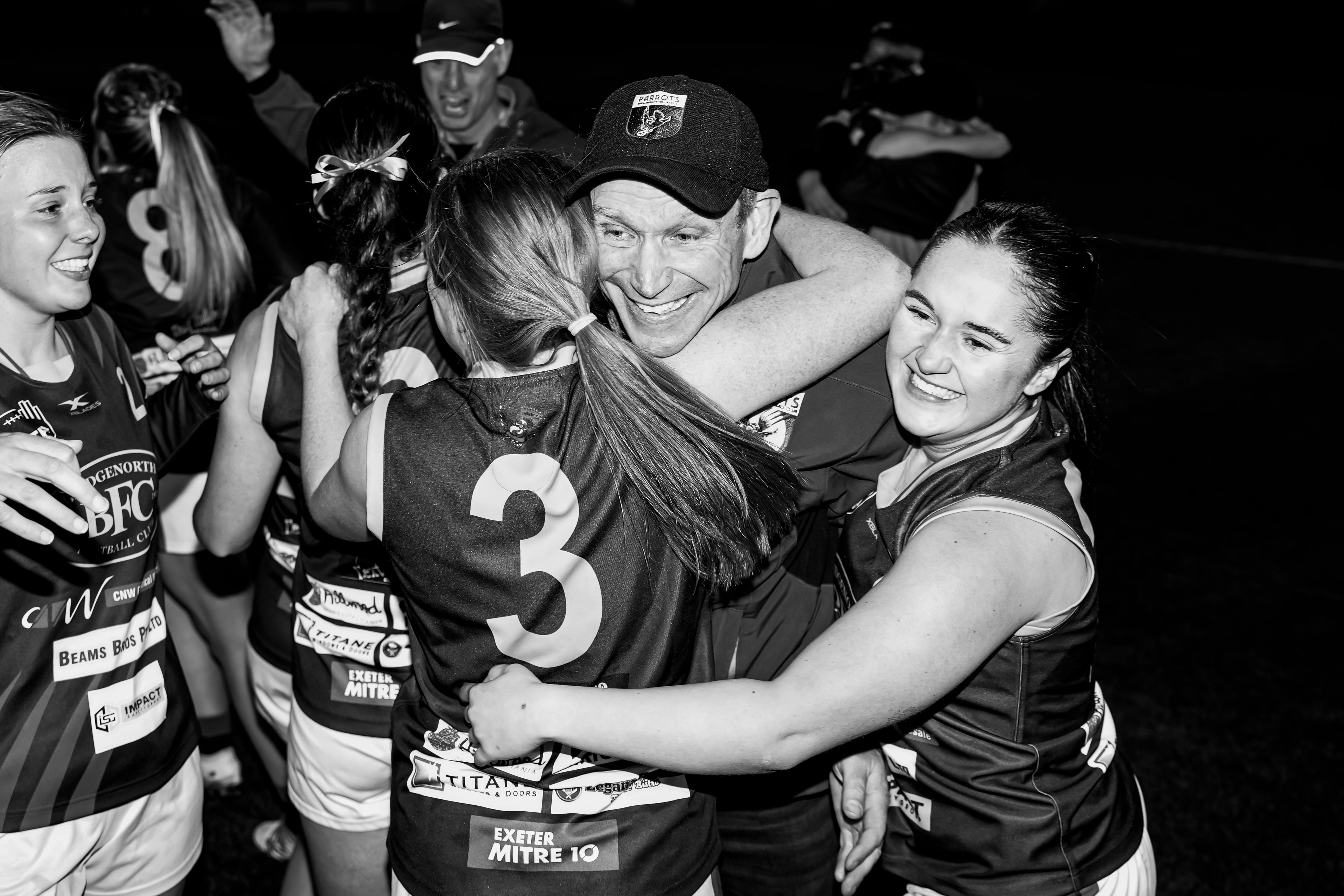 Black and white photo of senior womens team celebrating