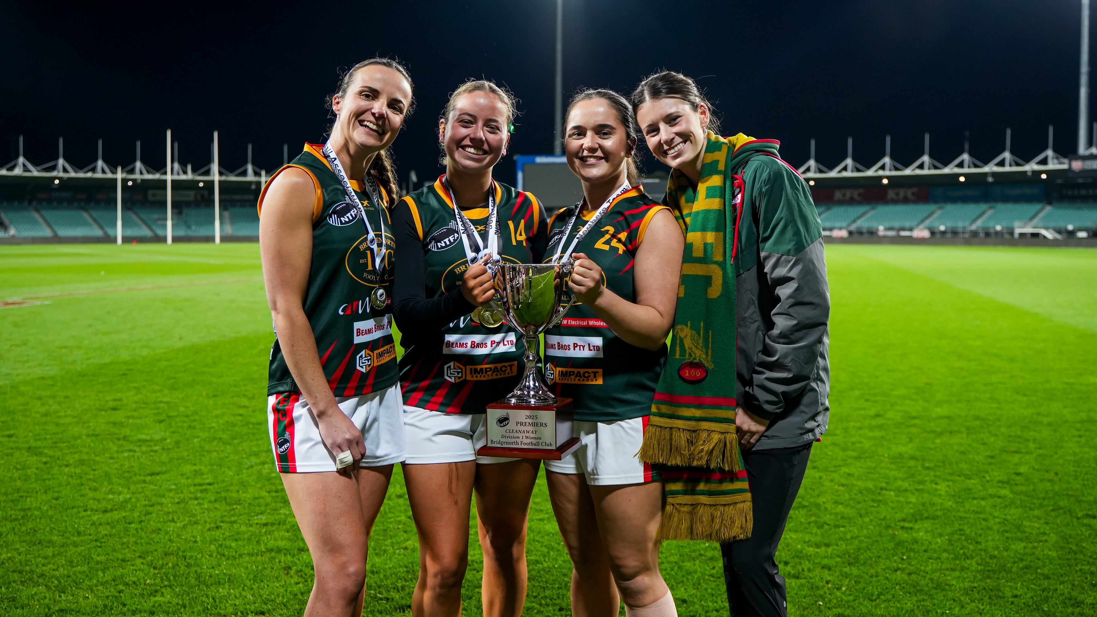 Four of our senior womens team holding the 2025 premiership cup