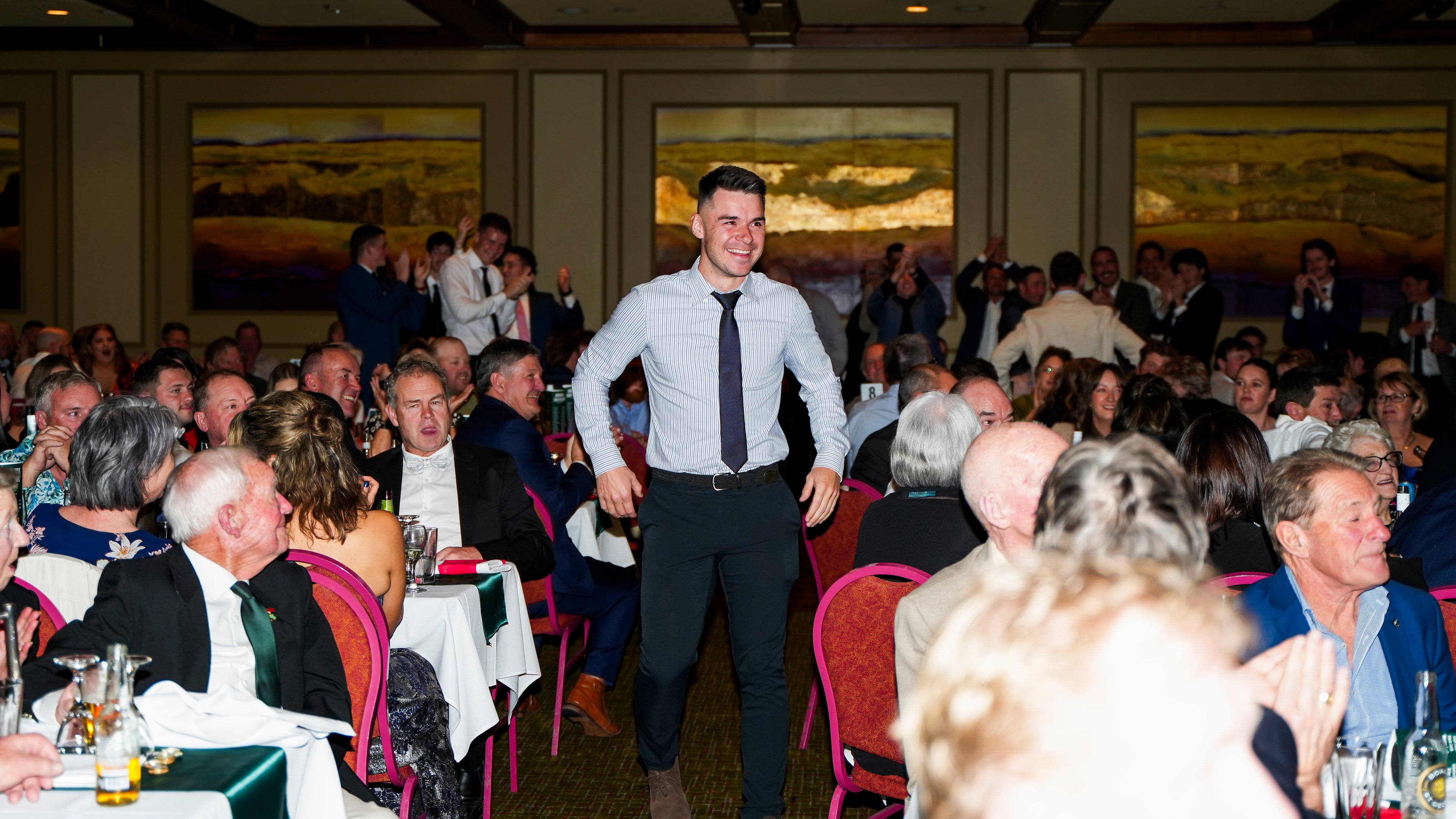 Matt Zanetto walking to the stage to accept his team of the century position
