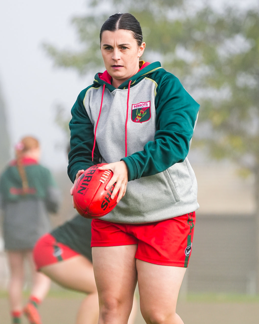 Sharmo in Bridgenorth attire holding a red ball on a field