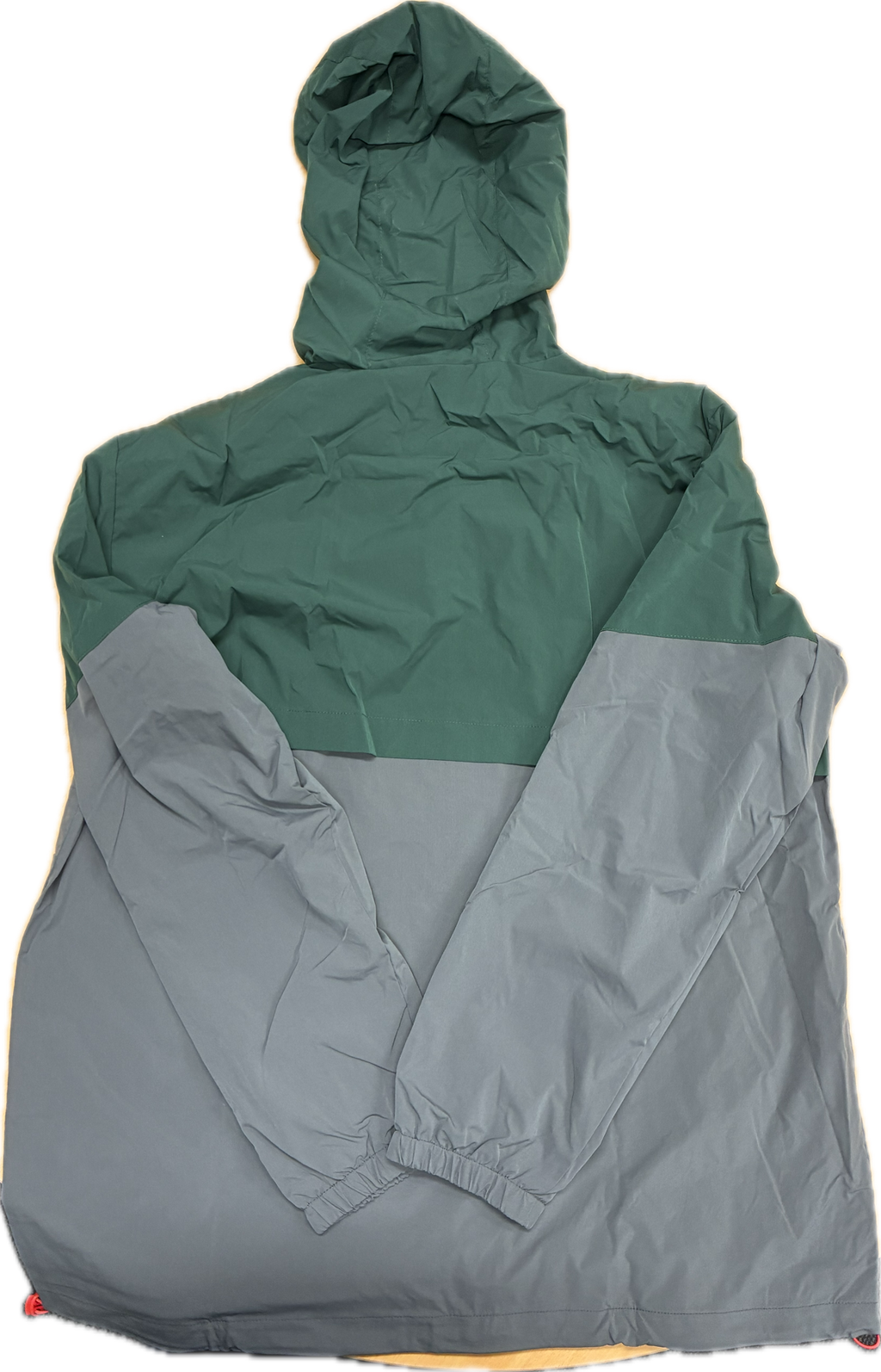 Green and gray spray jacket with hood on a white background