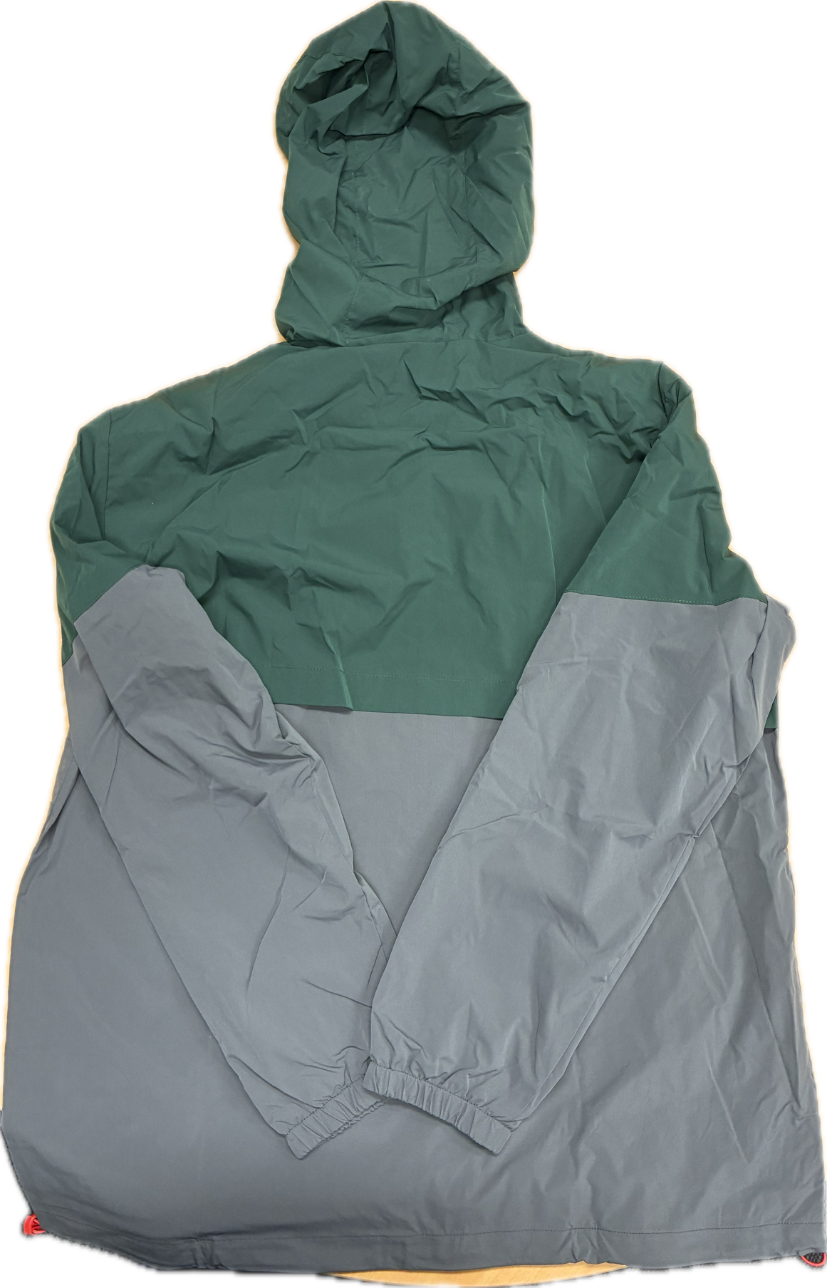 Green and gray spray jacket with hood on a white background